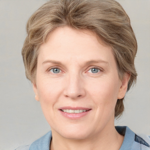 Joyful white adult female with medium  brown hair and blue eyes