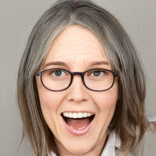 Joyful white adult female with medium  brown hair and blue eyes