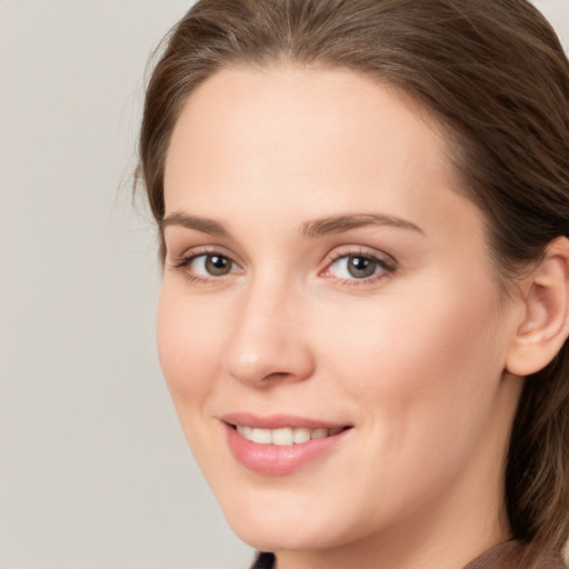 Joyful white young-adult female with long  brown hair and grey eyes