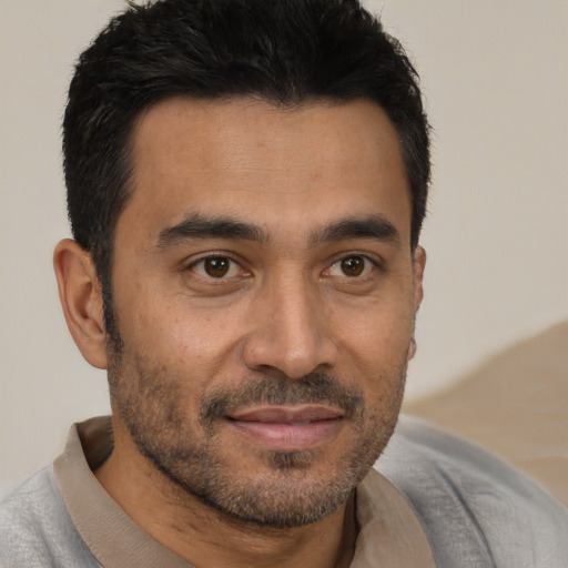 Joyful asian adult male with short  black hair and brown eyes