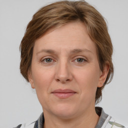 Joyful white adult female with medium  brown hair and grey eyes