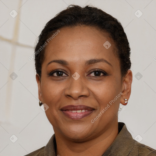 Joyful black adult female with short  black hair and brown eyes