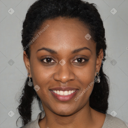 Joyful black young-adult female with long  black hair and brown eyes