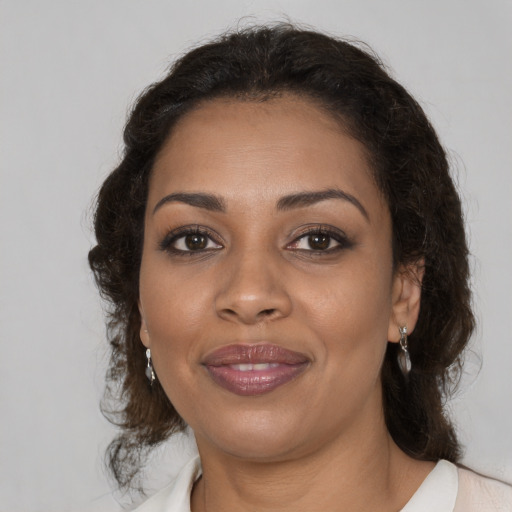 Joyful black young-adult female with medium  brown hair and brown eyes
