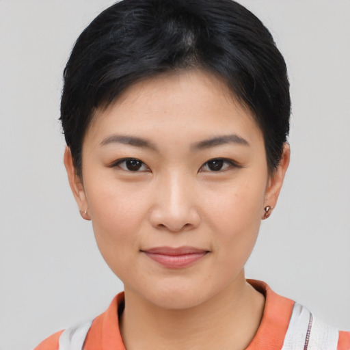 Joyful asian young-adult female with short  black hair and brown eyes