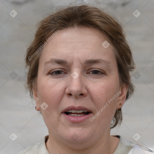 Joyful white adult female with medium  brown hair and grey eyes