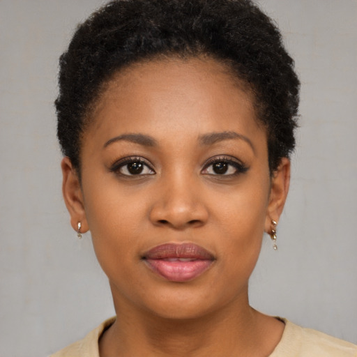 Joyful black young-adult female with short  brown hair and brown eyes