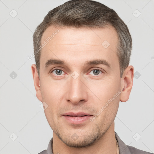 Neutral white young-adult male with short  brown hair and grey eyes