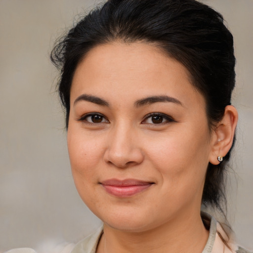 Joyful latino young-adult female with medium  brown hair and brown eyes