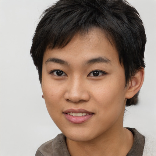 Joyful asian young-adult female with short  brown hair and brown eyes