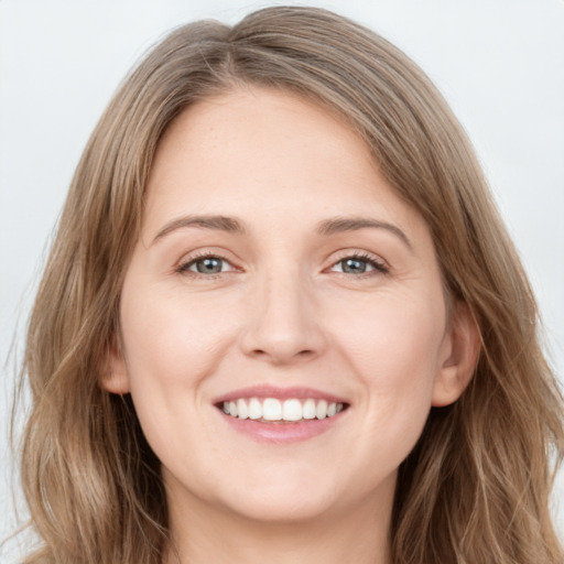 Joyful white young-adult female with long  brown hair and green eyes