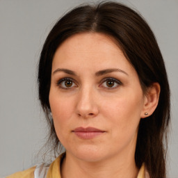 Joyful white adult female with long  brown hair and brown eyes