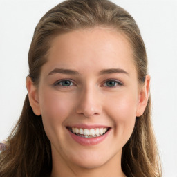 Joyful white young-adult female with long  brown hair and blue eyes