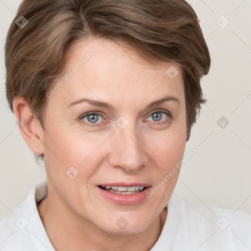 Joyful white adult female with short  brown hair and blue eyes