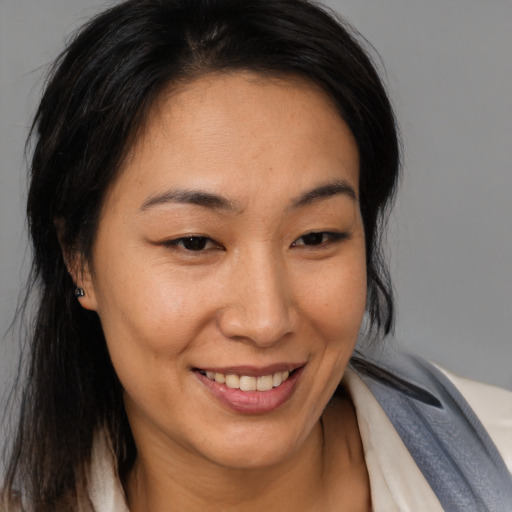 Joyful asian young-adult female with medium  brown hair and brown eyes