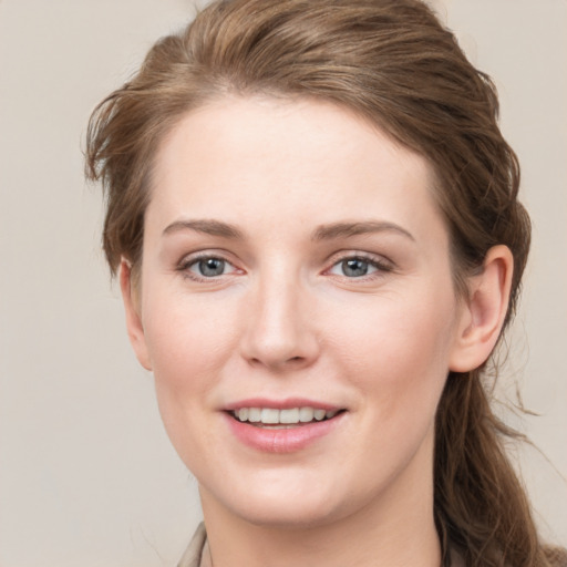 Joyful white young-adult female with long  brown hair and grey eyes