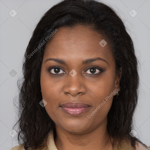 Joyful black young-adult female with long  brown hair and brown eyes