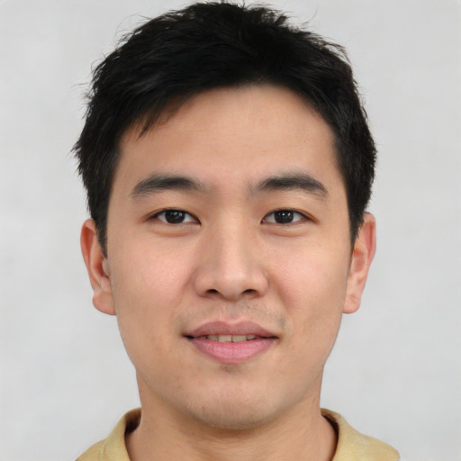 Joyful asian young-adult male with short  brown hair and brown eyes