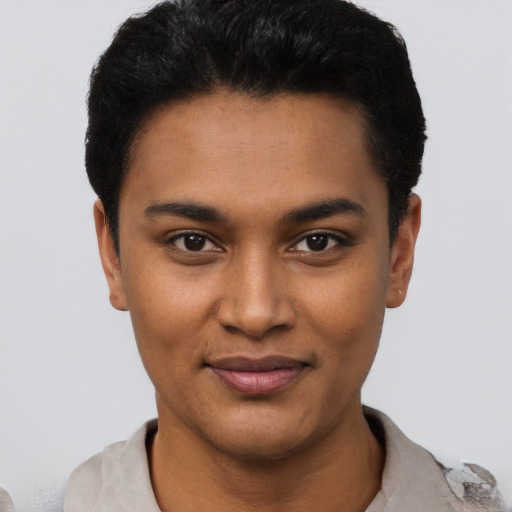 Joyful black young-adult male with short  black hair and brown eyes