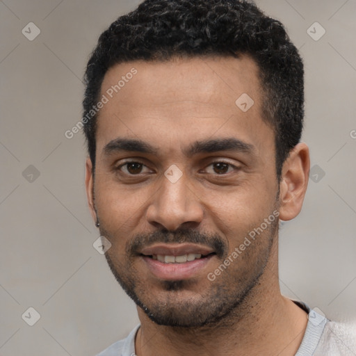 Joyful black young-adult male with short  black hair and brown eyes