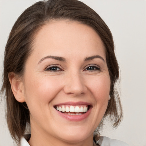 Joyful white young-adult female with medium  brown hair and brown eyes