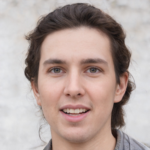 Joyful white young-adult male with medium  brown hair and brown eyes