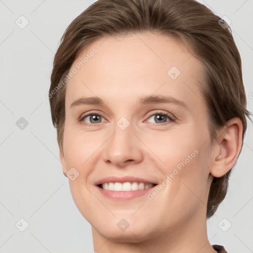 Joyful white young-adult female with short  brown hair and grey eyes