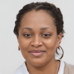 Joyful black adult female with short  brown hair and brown eyes
