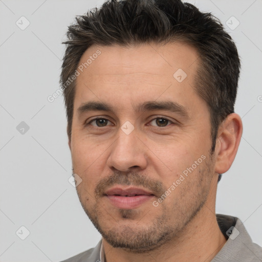 Joyful white adult male with short  brown hair and brown eyes