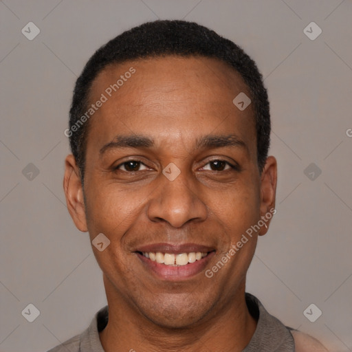 Joyful latino adult male with short  black hair and brown eyes