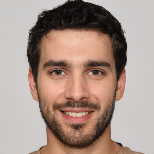 Joyful white young-adult male with short  black hair and brown eyes