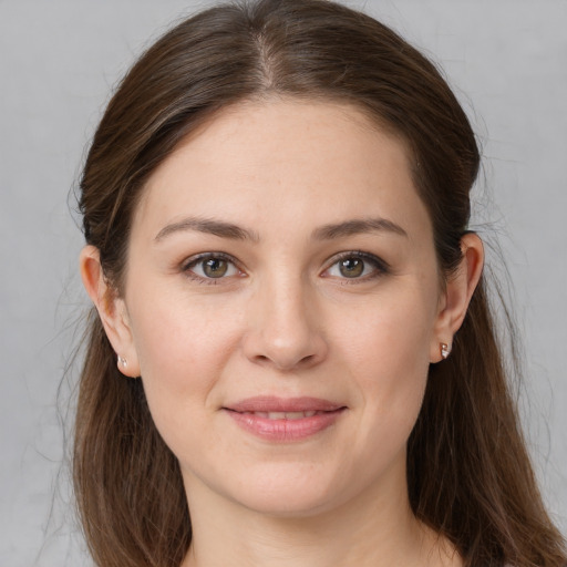 Joyful white young-adult female with long  brown hair and grey eyes