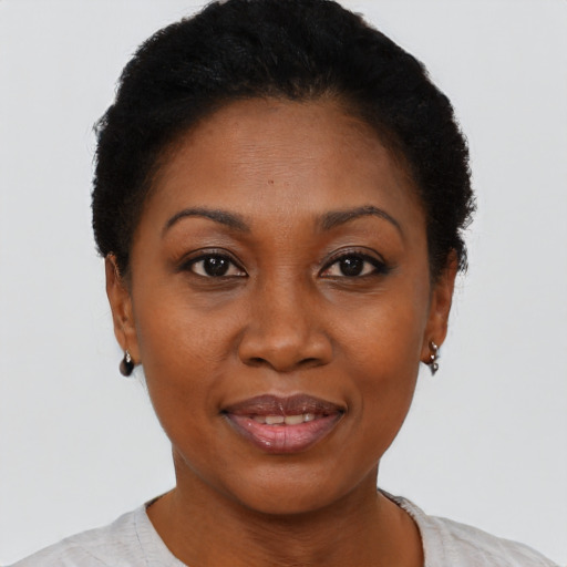 Joyful black adult female with short  black hair and brown eyes