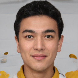 Joyful asian young-adult male with short  brown hair and brown eyes