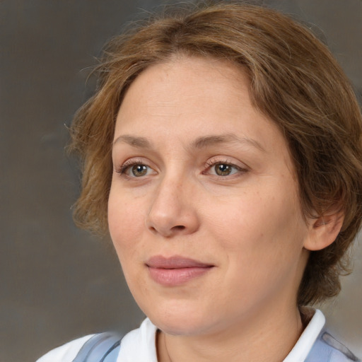 Joyful white adult female with medium  brown hair and brown eyes