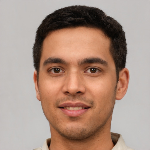 Joyful white young-adult male with short  brown hair and brown eyes