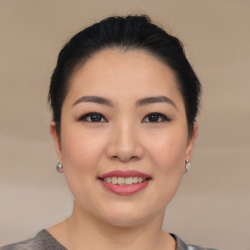 Joyful asian young-adult female with short  black hair and brown eyes