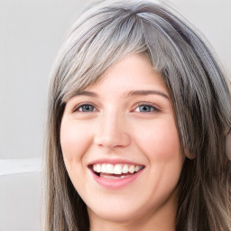 Joyful white young-adult female with long  brown hair and blue eyes