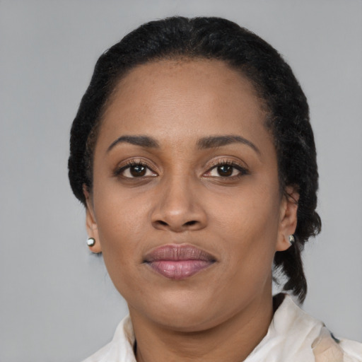 Joyful black adult female with short  black hair and brown eyes