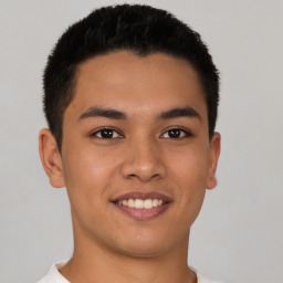 Joyful latino young-adult male with short  brown hair and brown eyes