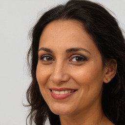 Joyful white adult female with long  brown hair and brown eyes