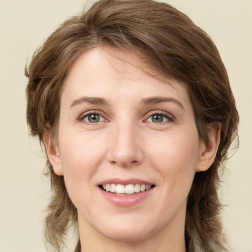 Joyful white young-adult female with medium  brown hair and green eyes