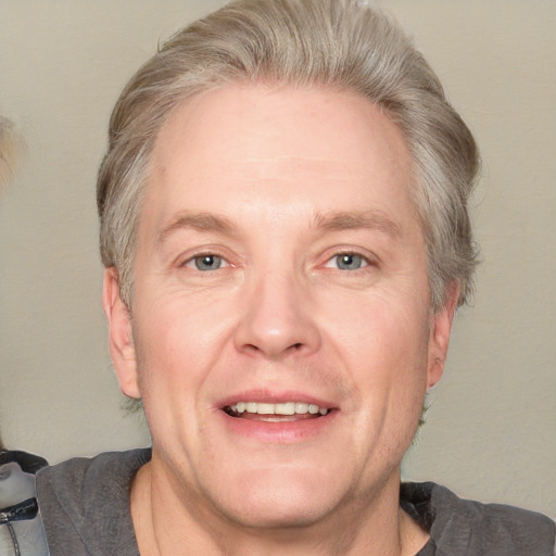 Joyful white adult male with short  brown hair and grey eyes