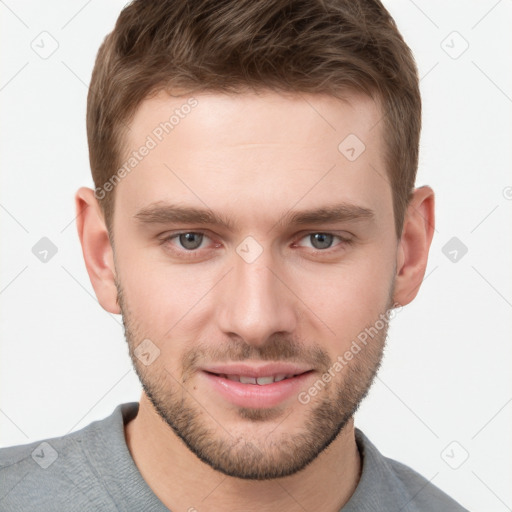 Joyful white young-adult male with short  brown hair and grey eyes