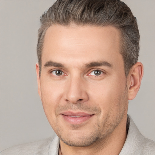 Joyful white adult male with short  brown hair and brown eyes