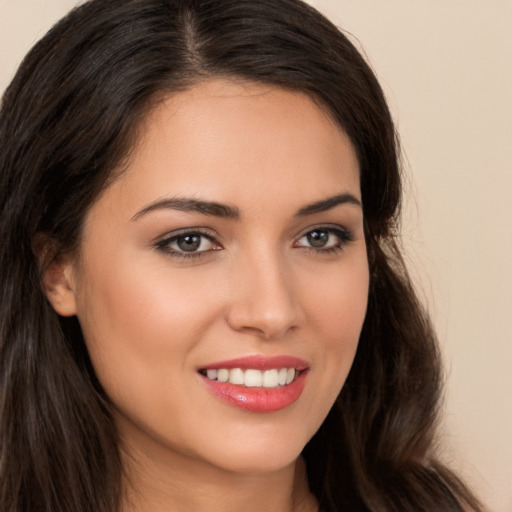 Joyful white young-adult female with long  brown hair and brown eyes