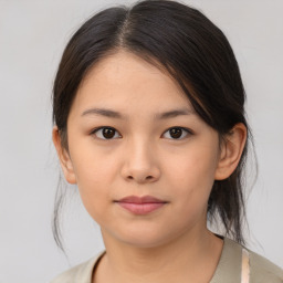 Joyful white child female with medium  brown hair and brown eyes