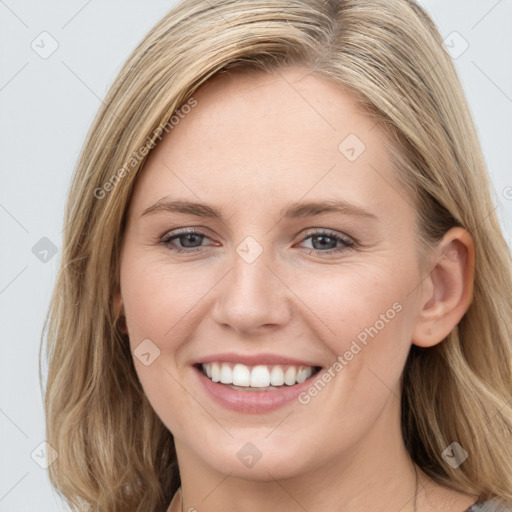 Joyful white young-adult female with long  brown hair and blue eyes