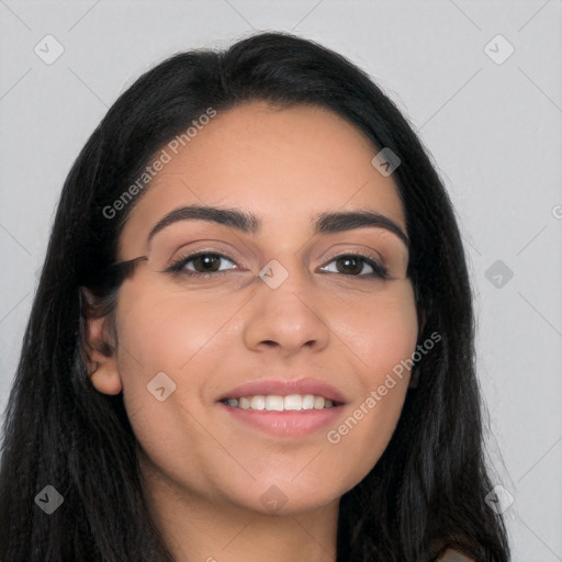 Joyful latino young-adult female with long  black hair and brown eyes