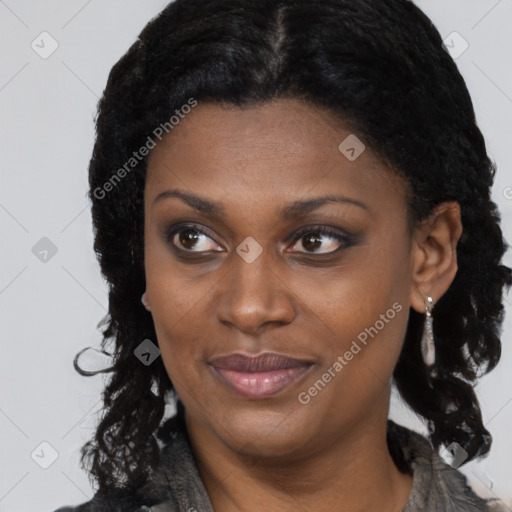 Joyful black young-adult female with long  brown hair and brown eyes